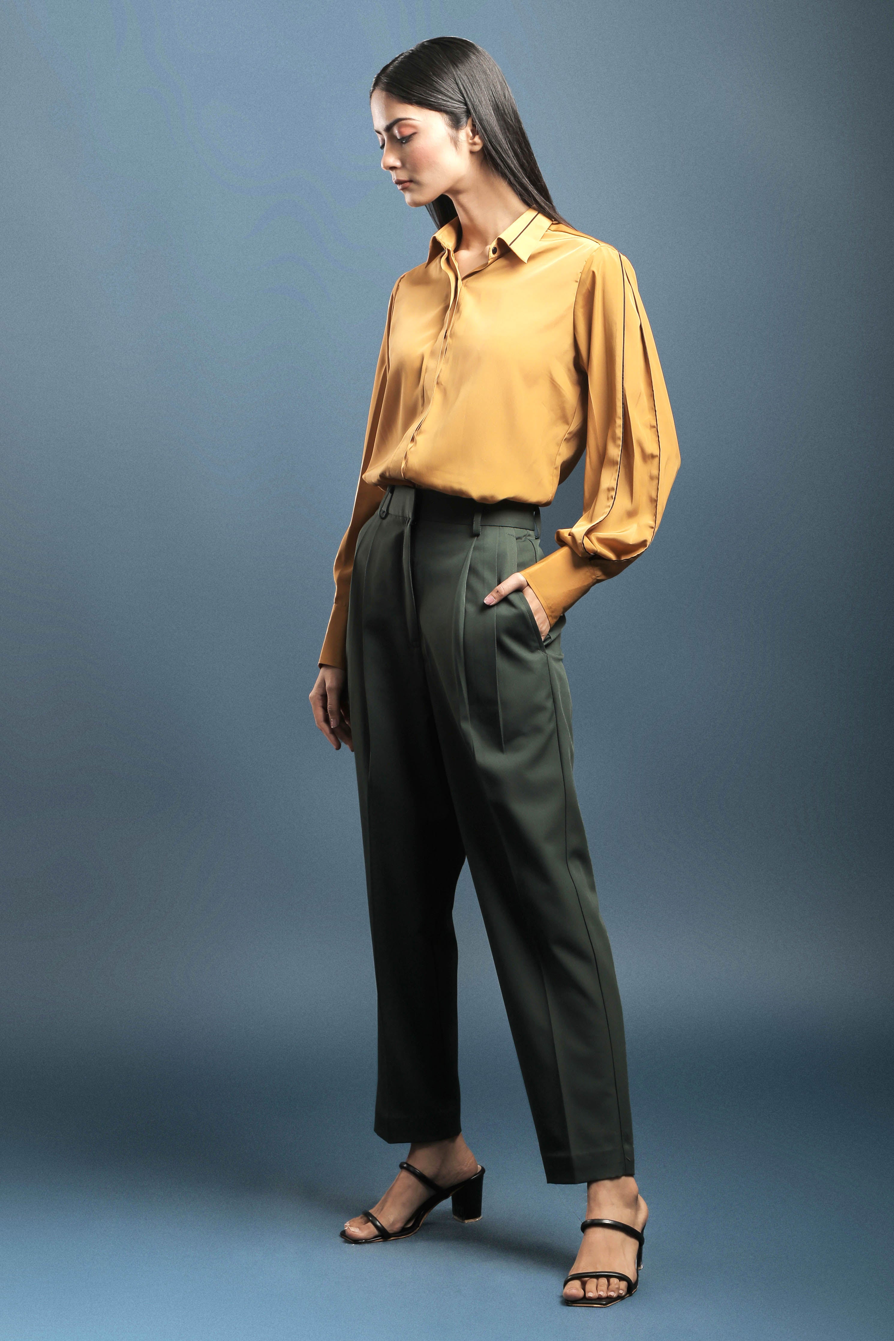 Premium Photo | A woman in a yellow shirt and brown pants sitting on a stool